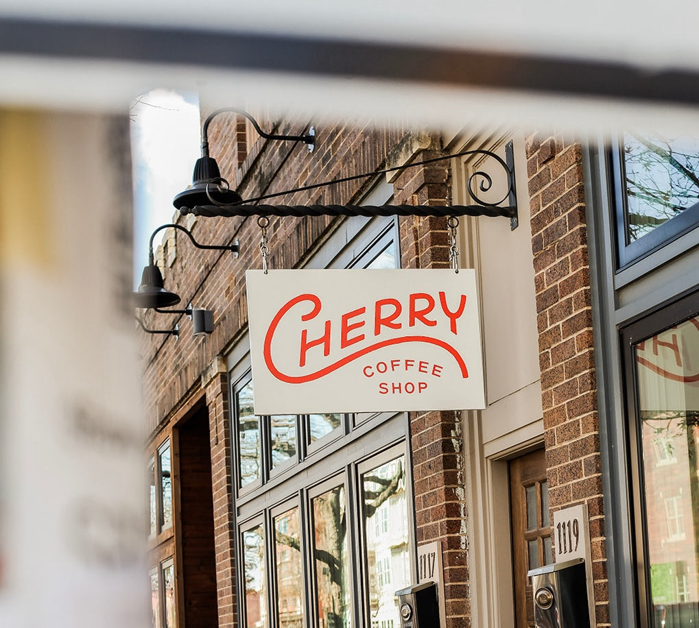 photograph of outdoor sign hanging above cherry coffee shop