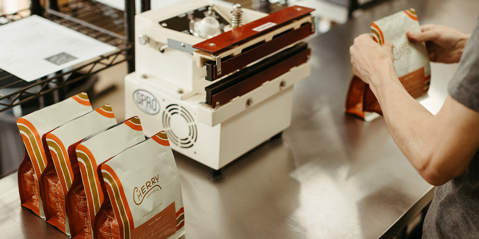 photograph of cherry coffee bags being sealed in production space