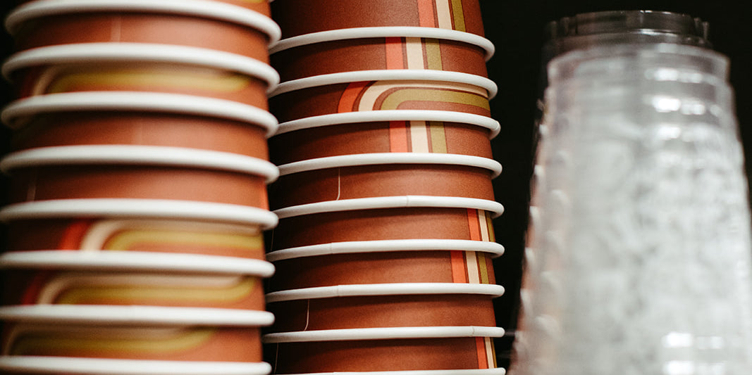 photograph of upside down stacked branded cherry coffee shop to-go cups