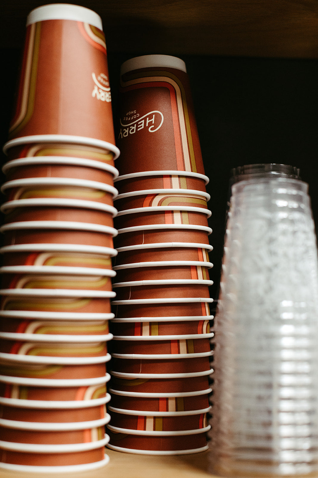 photograph of upside down stacked branded cherry coffee shop to-go cups