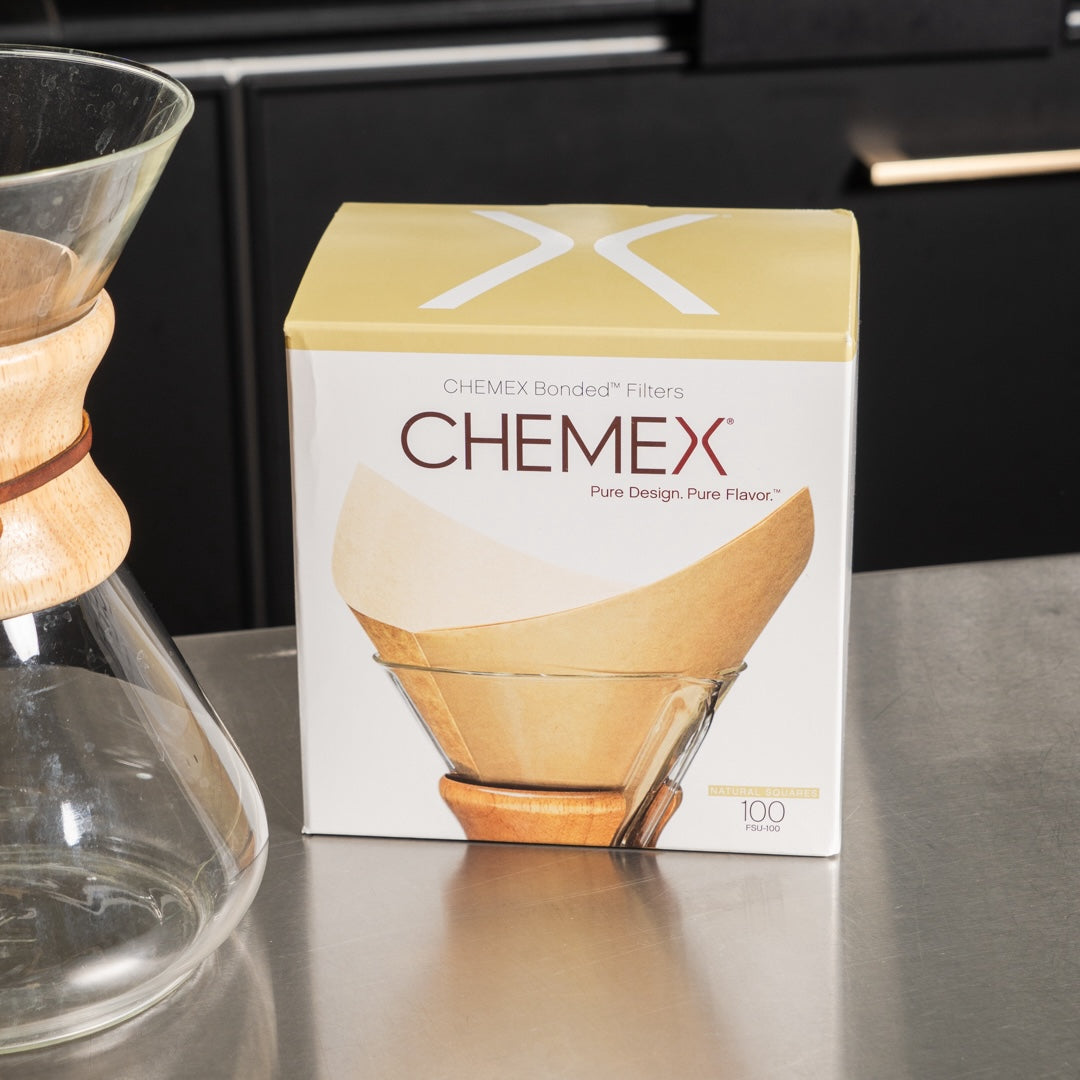 photograph of a box of chemex bonded filters next to an emtpy chemex container