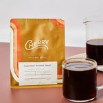 photograph of 'sugarcane process decaf' coffee next to a cup and carafe of brewed coffee